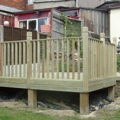 A raised decking area with handrail under construction